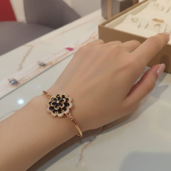 likely gold plated stainless steel or high quality alloy with a polished finish. band style: a hybrid design. the top portion features a brick link pattern (multi link) that transitions into a solid, smooth bangle style cuff at the back. closure: typically features a jewelry style clasp or a hinged spring opening for a seamless "bracelet" look on the wrist.